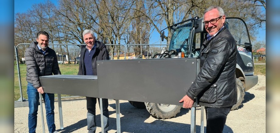 Ein neues Gerät für den Calisthenics-Park, links im Bild der erste Beigeordnete Sascha Hofmann, in der Bildmitte Bernd Rappenecker vom städtischen Bauamt und recht im Bild Bürgermeister Marcus Schaile